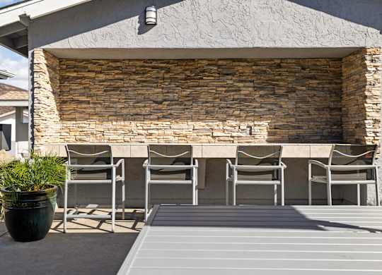 A patio with a table and chairs is set up outside a house.