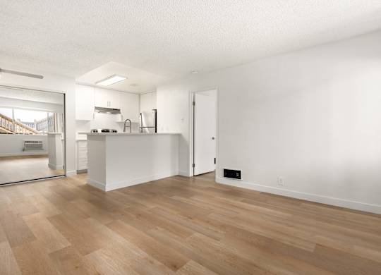 A room with wooden floors and white walls.