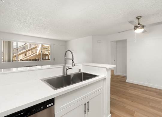A kitchen with a sink and a window.