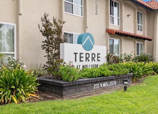 A sign for Terre at Nollison in front of a building.
