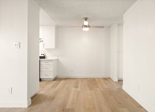 A room with wooden floors and white walls.