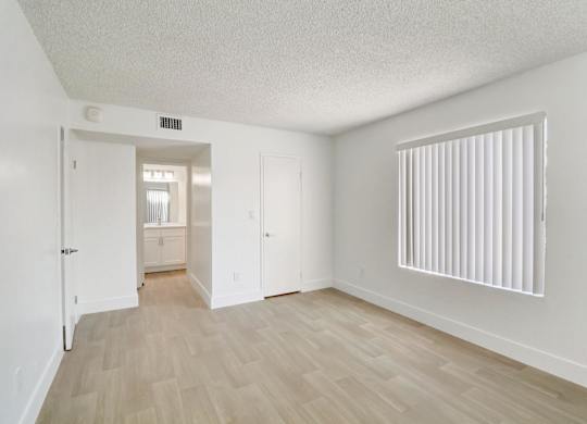 A room with a wooden floor and white walls.