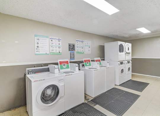 A row of washing machines in a laundromat.