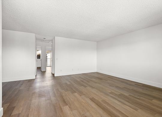 A room with wooden floors and white walls.