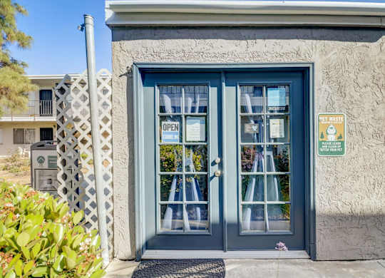 A blue door with a sign that says