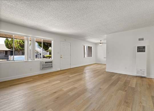 A room with wooden floors and white walls.