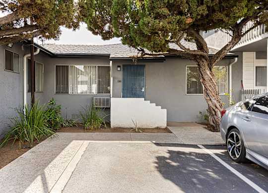 A house with a tree in front of it.