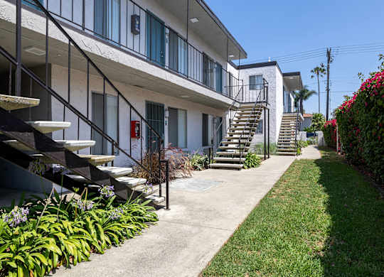 A building with a staircase and a red fire hydrant.