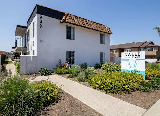 A white building with a sign that says