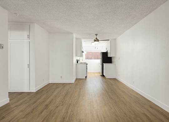 A room with wooden floors and white walls.