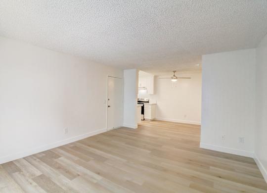 A room with wooden floors and white walls.