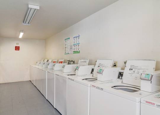 A laundromat with rows of washing machines.
