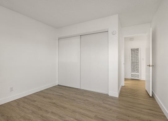 A room with a sliding door and a heater on the wall.