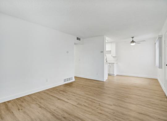 A room with wooden floors and white walls.