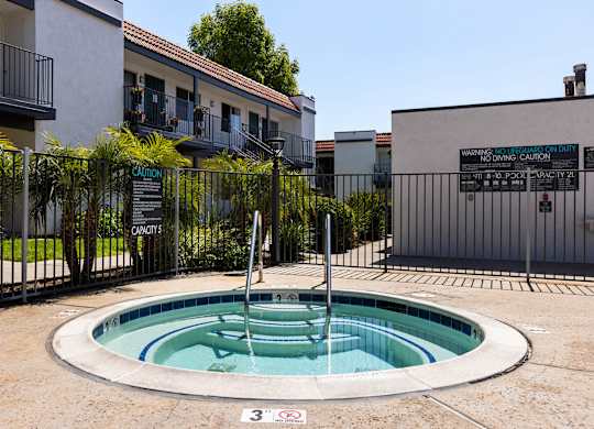 A pool with a warning sign in front of a building.