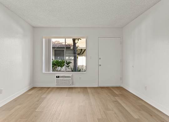 A room with a window and a door.