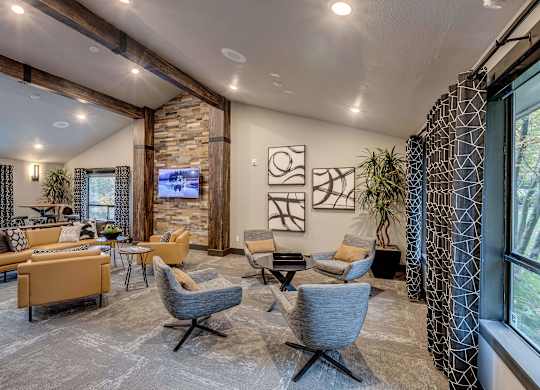 A living room with a stone wall and a large window.