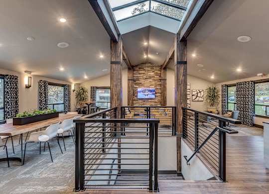 A modern interior with a skylight and a stone pillar.