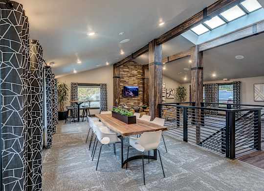 A modern dining room with a wooden table and chairs.