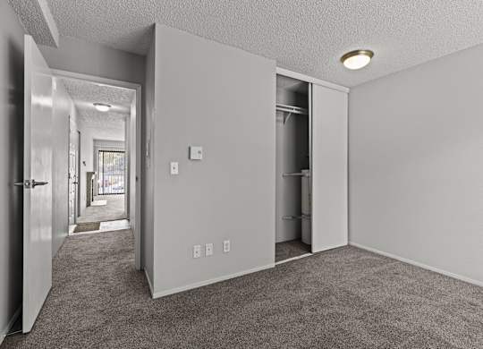 A room with a carpeted floor and white walls.