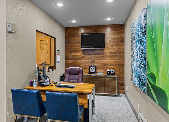 A room with a wooden wall and a television mounted on it.