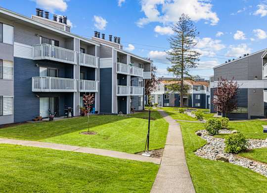 Apartment complex with a walkway between the buildings.