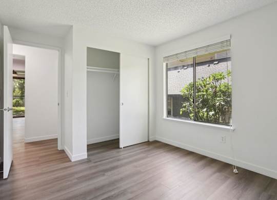 A room with a window and a door.