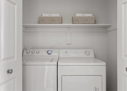 A small laundry room with a washer and dryer.