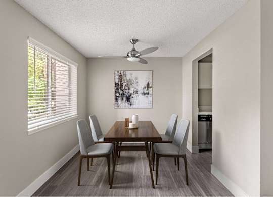 A dining room with a wooden table and chairs.
