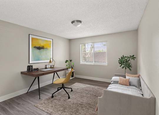 A room with a bed, desk, and chair.
