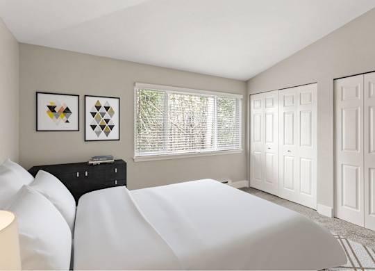 A bedroom with a white bed and two framed pictures on the wall.
