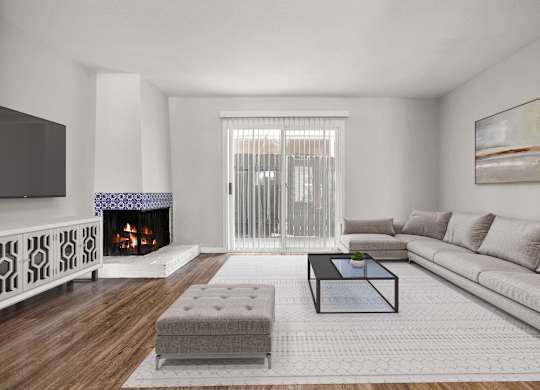 A modern living room with a fireplace and a couch.