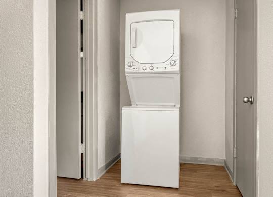 A white washing machine in a small room.