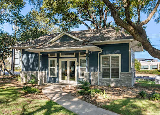 A blue house with a white door and windows.