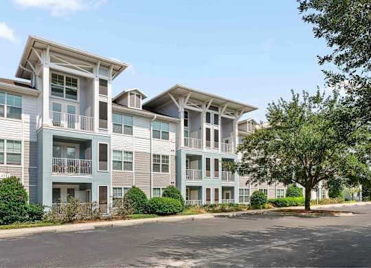 A large building with parking in front of it.