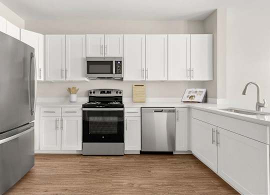 A kitchen with appliances and white cabinets.