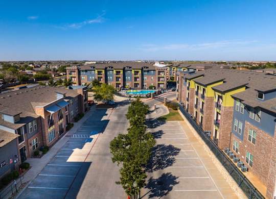 A sunny day at a residential complex with a clear blue sky.