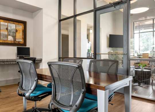 A conference room with a wooden table and chairs.