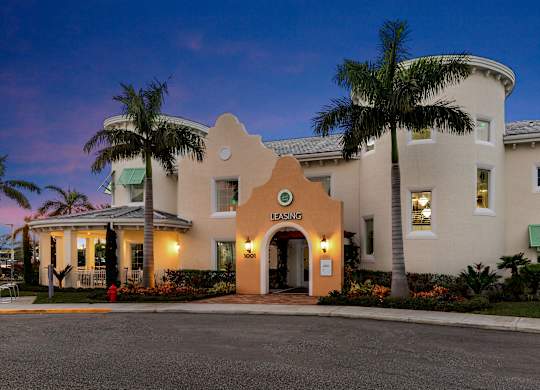 A building with a palm tree in front of it.