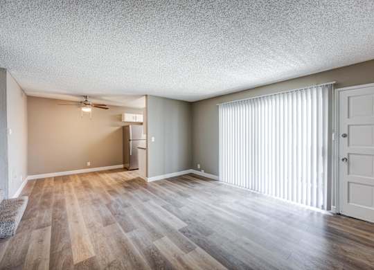 A room with wooden flooring and a white door.