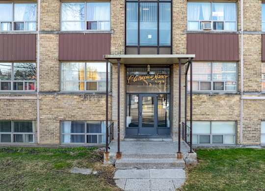 The front of a building with a glass door and windows.