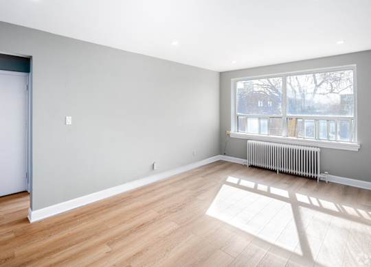 A room with wooden floors and a white door.