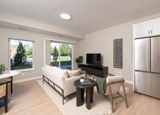 A modern living room with a white sofa and a black television.