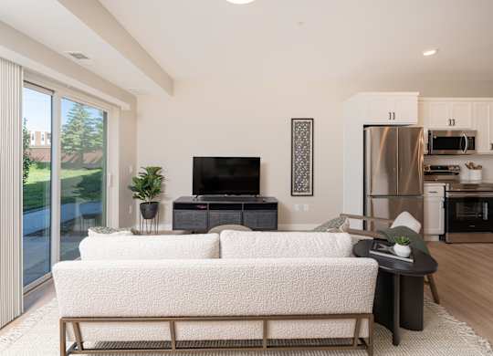 A modern living room with a white couch and a television.