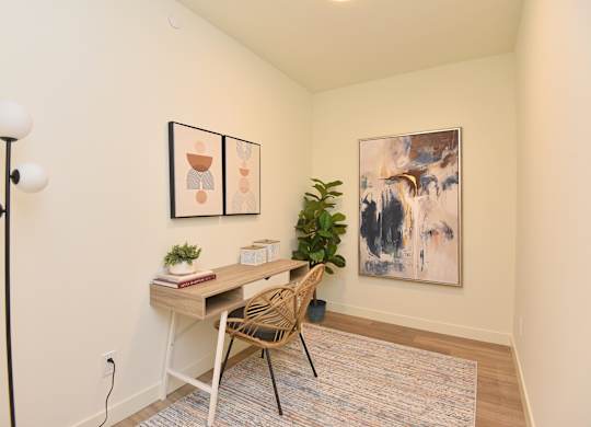 A room with a desk and chair in front of a painting at Roxy Apartments, Hamilton