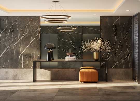 A modern office lobby with a marble wall and a circular light fixture.