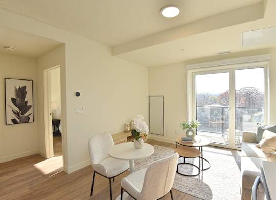 A modern living room with a white table and chairs at Roxy Apartments, Ontario
