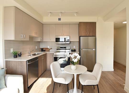 A kitchen with a table and chairs at Roxy Apartments, Ontario, L8H 0B7