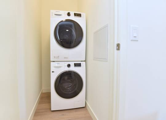A white front loading washing machine at Roxy Apartments, Hamilton, ON