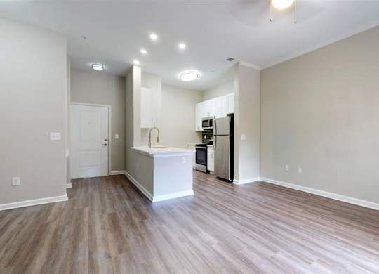 A kitchen area with a white countertop and wooden flooring. at Vue at Embry Hills, Atlanta, GA, 30042